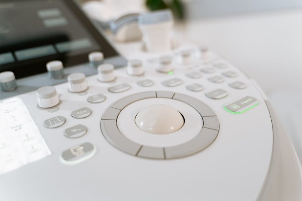 Detailed close-up of ultrasound machine controls in a medical facility.