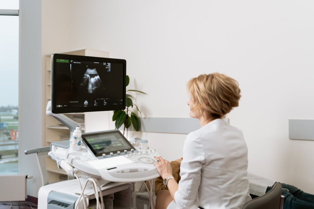 A healthcare professional conducting an ultrasound scan in a clinic setting.
